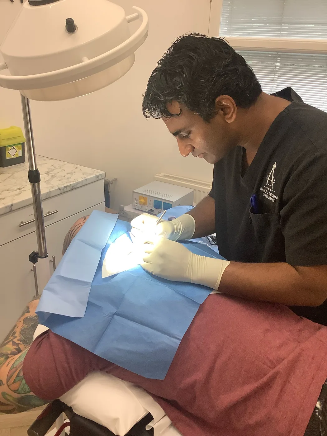 Mr Samuel George removing a cyst under local anaesthetic at Precision Surgery Clinic